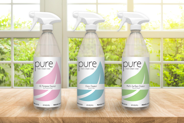 Digital 3d mockup of three Pure cleaner spray bottles with final label art.